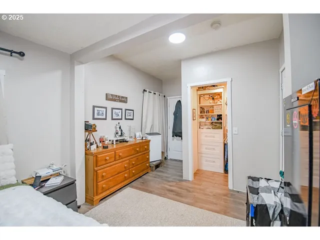 a bedroom with furniture and wooden floor
