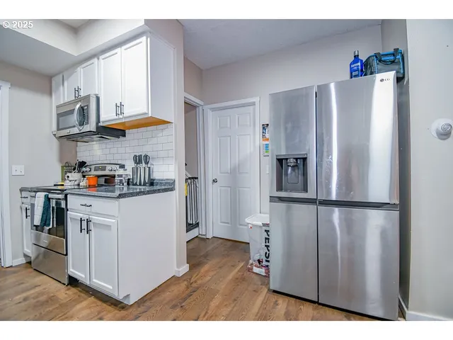 a kitchen with stainless steel appliances a refrigerator and a stove