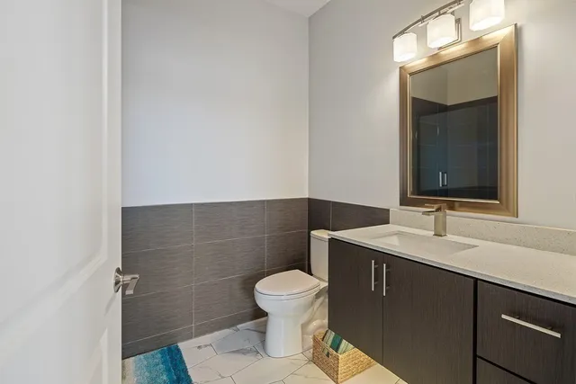 a bathroom with a toilet a sink and mirror