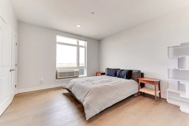 a bedroom with a bed and a window