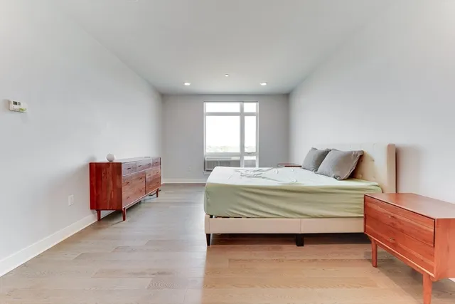 a spacious bedroom with a bed and window