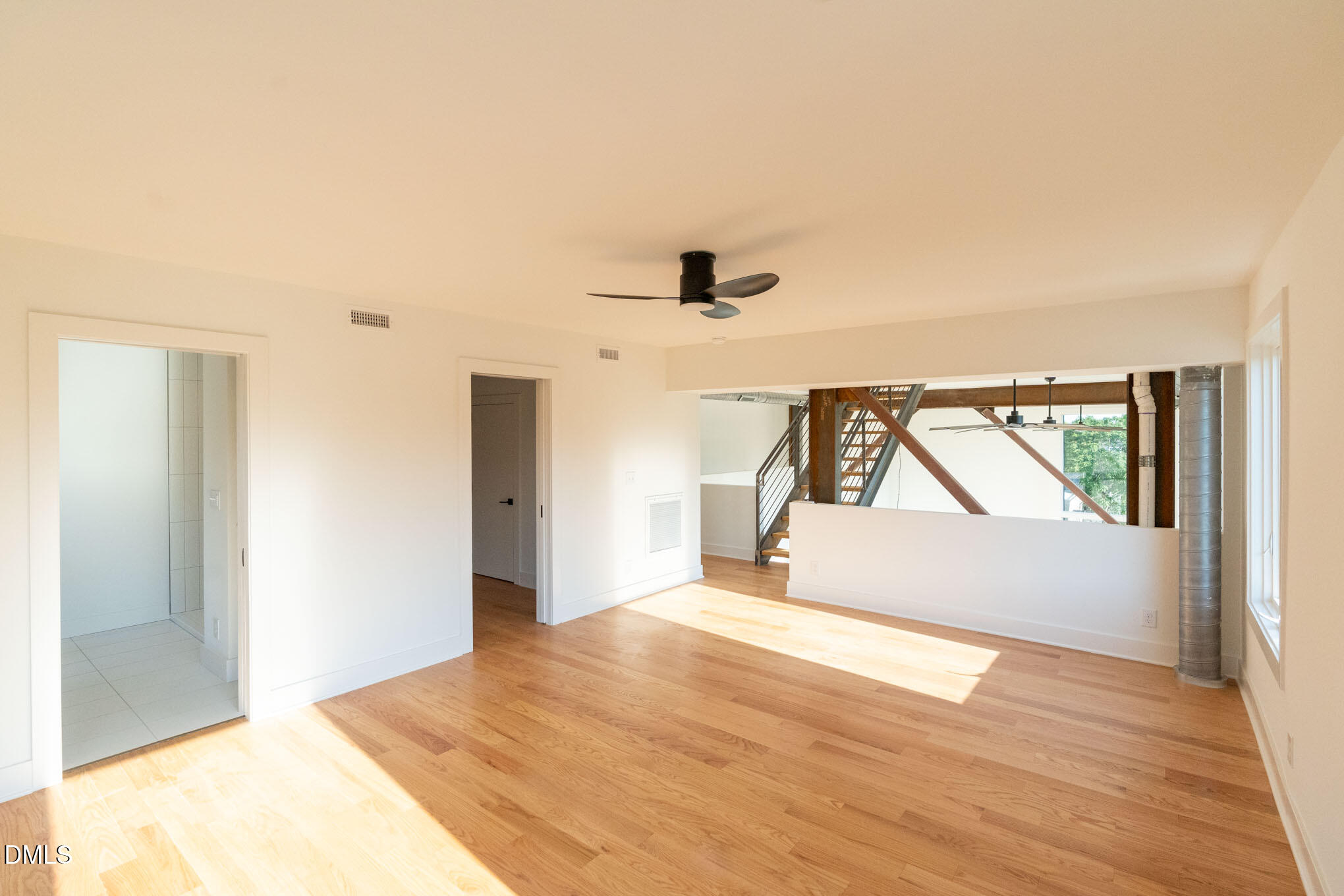 400 East Martin Street, Unit A Raleigh, NC 27601 - Photo 16 of 29 a view of an empty room with wooden floor and a window