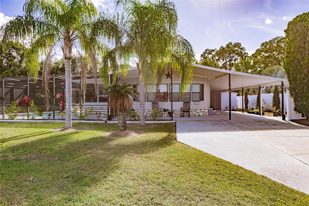 a swimming pool with outdoor seating and yard