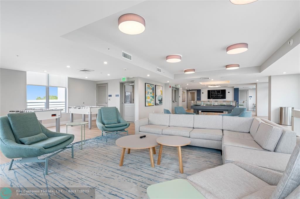 200 Northeast 1st Avenue, Unit 105 Pompano Beach, FL 33060 - Photo 16 of 20 a living room with furniture and a view of kitchen