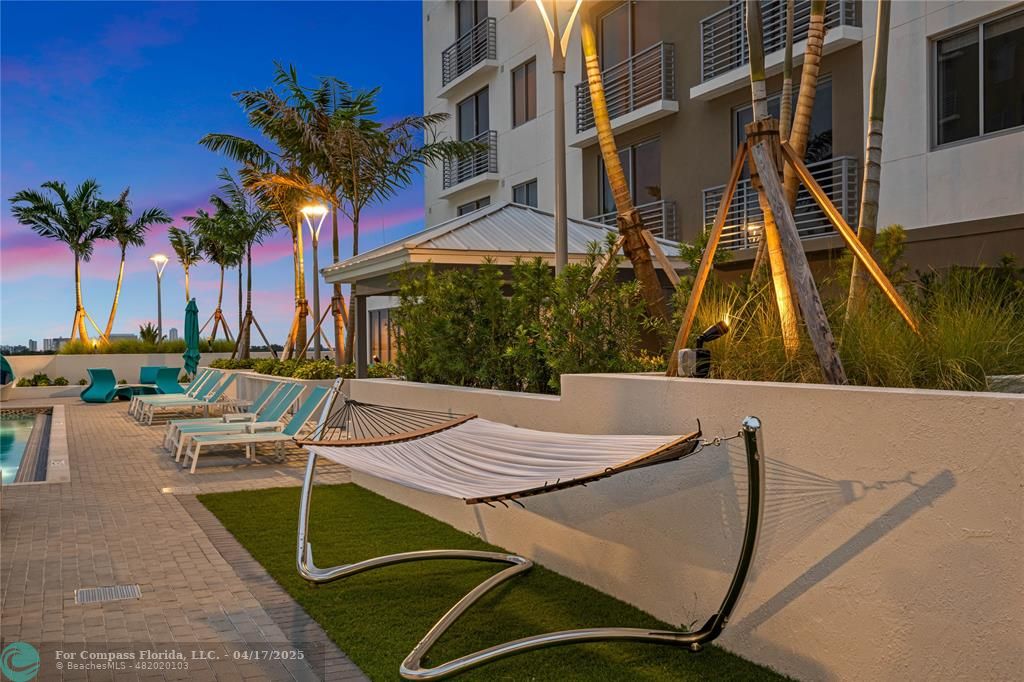 200 Northeast 1st Avenue, Unit 105 Pompano Beach, FL 33060 - Photo 18 of 20 a view of a patio with swimming pool