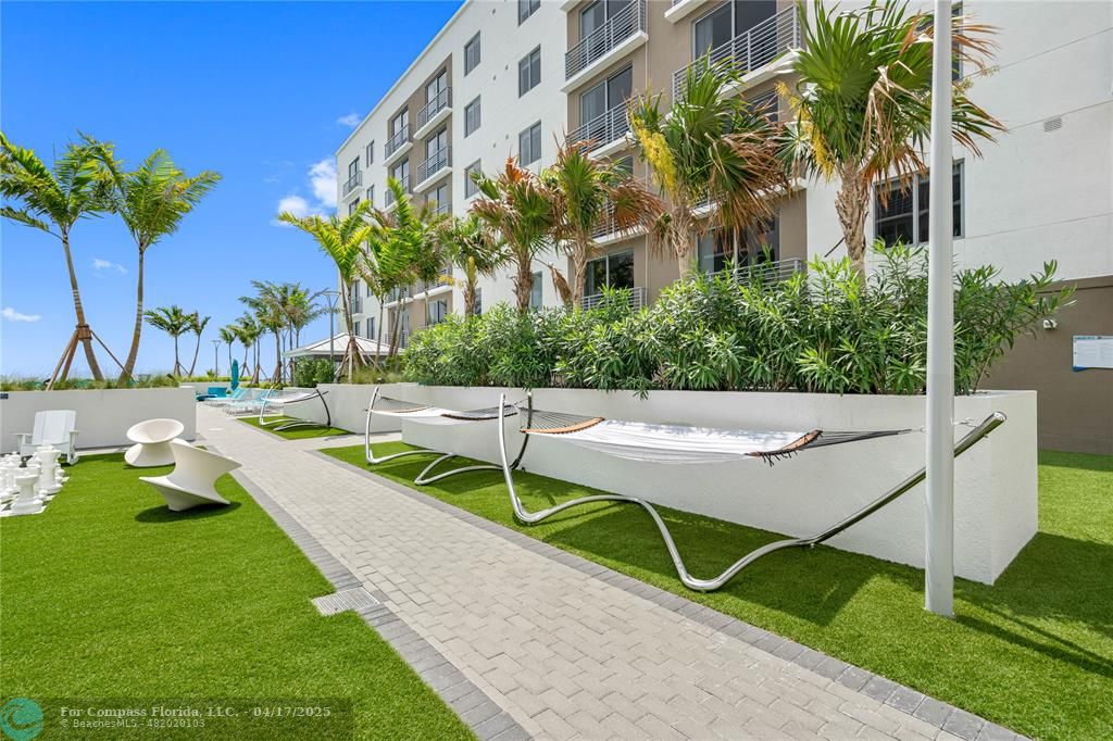 200 Northeast 1st Avenue, Unit 105 Pompano Beach, FL 33060 - Photo 7 of 20 a view of a swimming pool with a patio