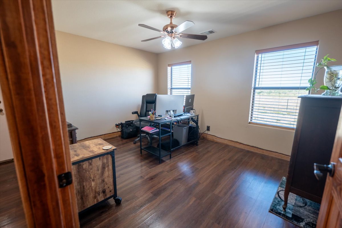 1825 Savanna Ridge Ranch Road Lometa, TX 76853 - Photo 22 of 35 Home office featuring dark wood-style flooring and a ceiling fan