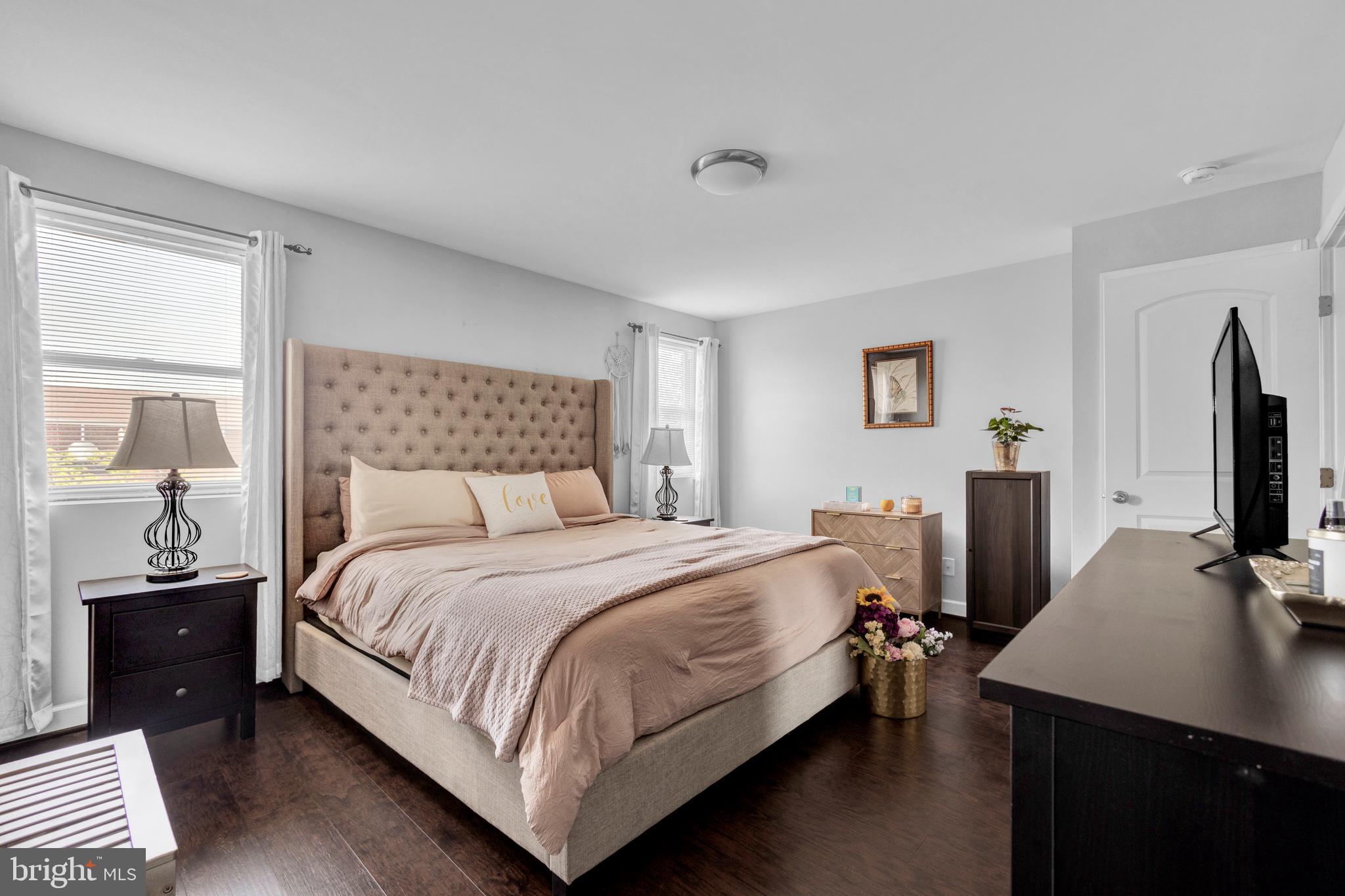 1823 Swansea Road Baltimore, MD 21239 - Photo 8 of 19 a bedroom with a bed table and a flat screen tv