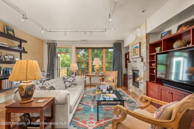 a living room with fireplace furniture and a flat screen tv