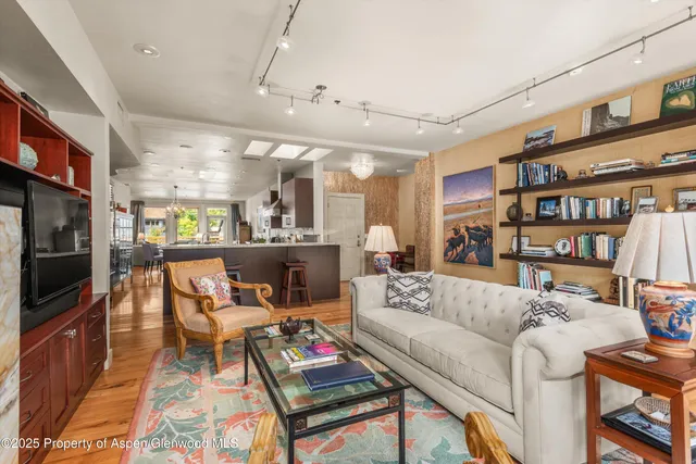 a living room with furniture a rug and a large window