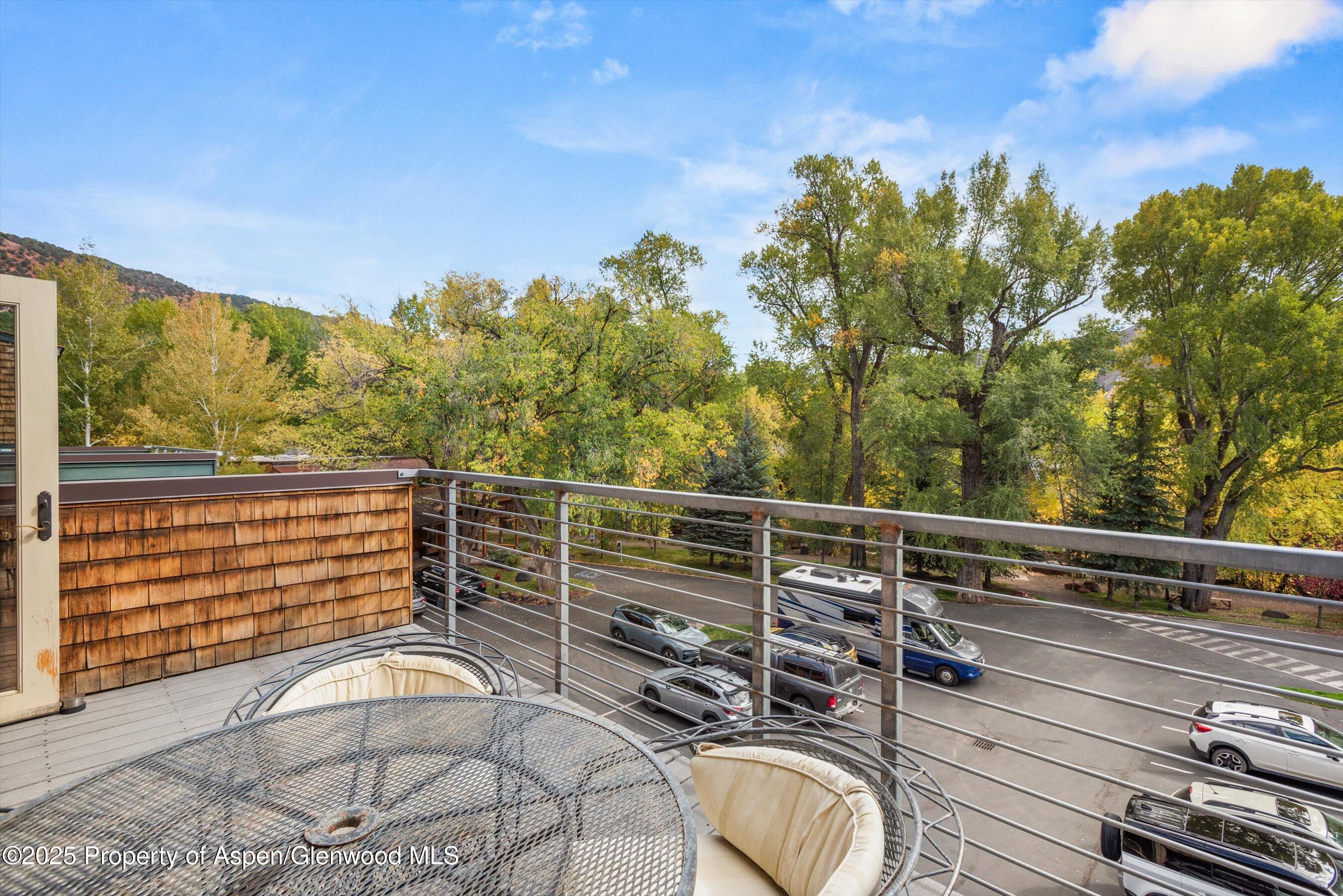 227 Midland Avenue, Unit 22 Basalt, CO 81621 - Photo 18 of 42 a view of a balcony with mountain view and wooden floor