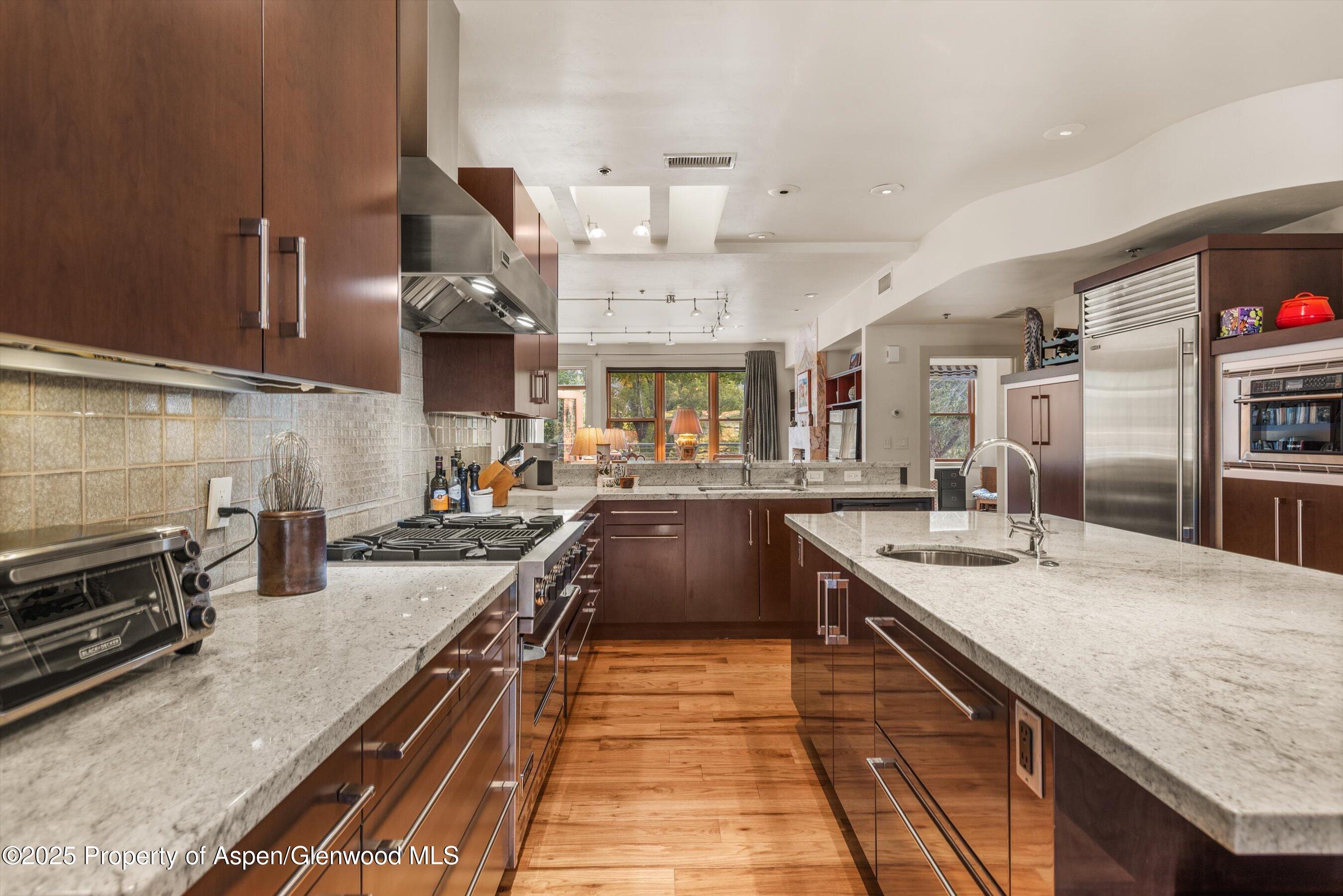 227 Midland Avenue, Unit 22 Basalt, CO 81621 - Photo 21 of 42 a large kitchen with stainless steel appliances granite countertop a lot of counter space and a sink