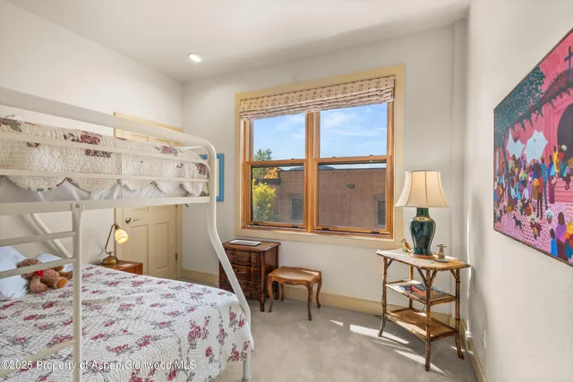 a bedroom with furniture and large windows