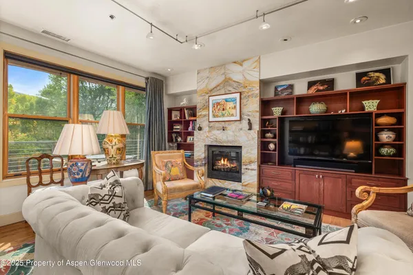 a kitchen with stainless steel appliances granite countertop a kitchen island a stove a table and chairs in it