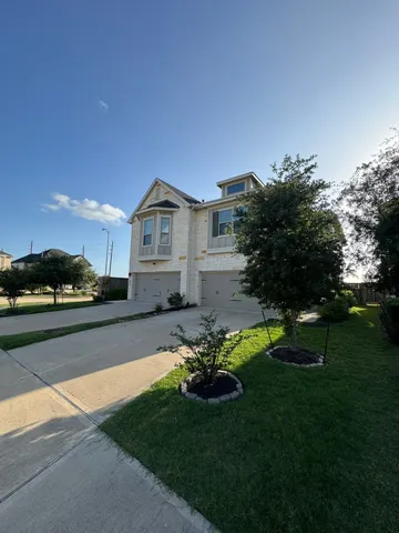 a view of a house with a big yard plants and large trees