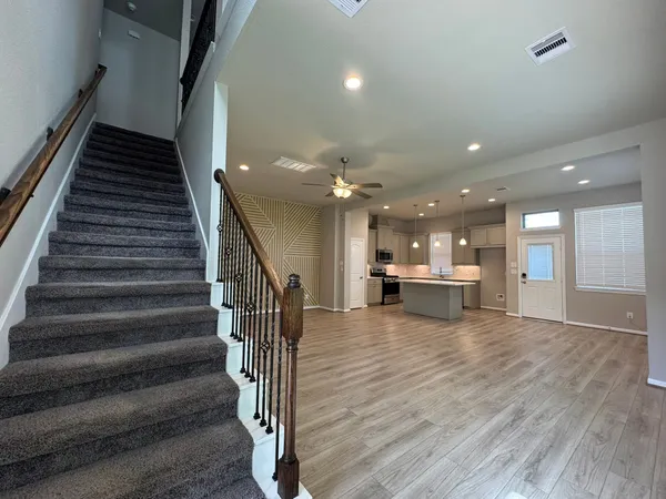 a view of kitchen and hall with wooden floor