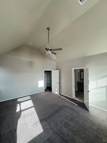 an empty room with windows and fireplace