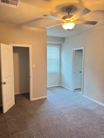a view of an empty room with a fan