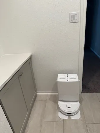 a white toilet sitting in a bathroom next to a sink