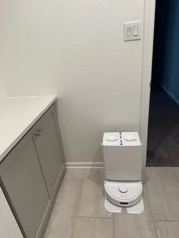 a white toilet sitting in a bathroom next to a sink