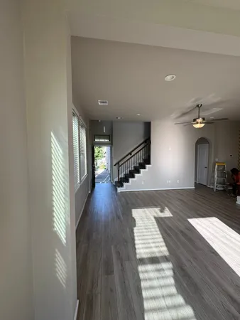 a view of a hallway view with wooden floor and staircase