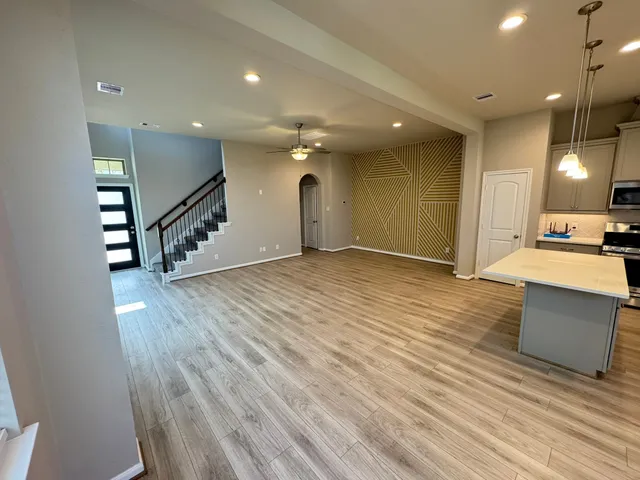 a view of a kitchen with cabinets and wooden floor