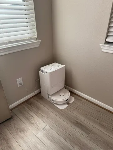 a view of a room with wooden floor and window