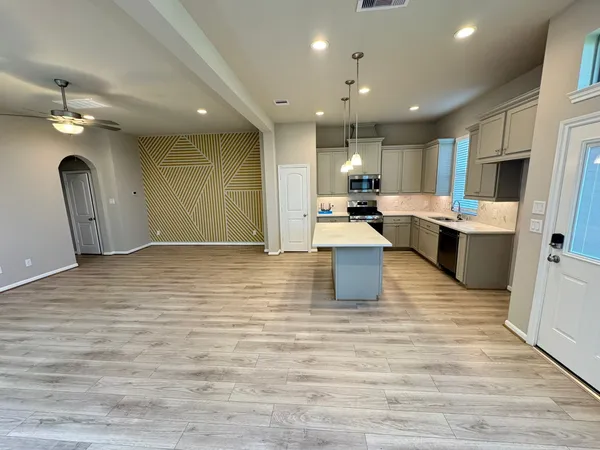 a large white kitchen with lots of counter space