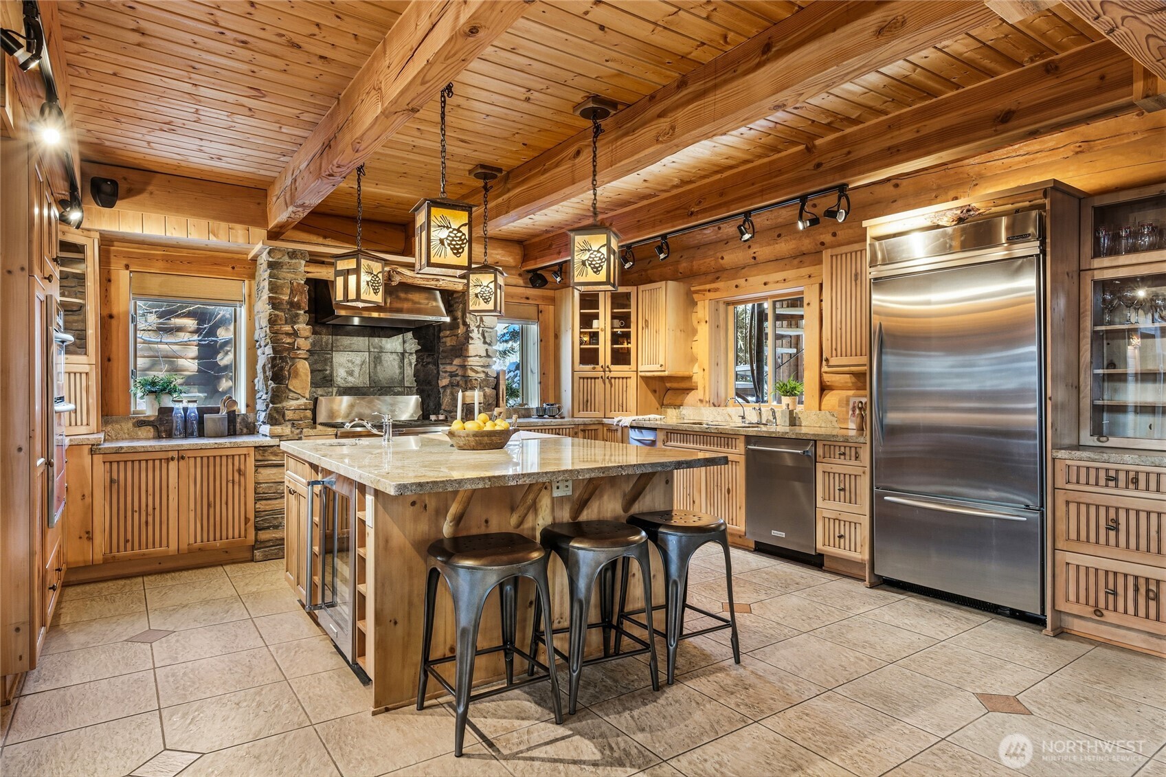 10 Rampart Way Snoqualmie Pass, WA 98068 - Photo 18 of 35 a kitchen with a sink a refrigerator and chairs