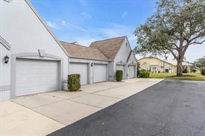 6807 Stone River Road, Unit 202 Bradenton, FL 34203 - Photo 2 of 12 a view of garage with deck and outdoor seating