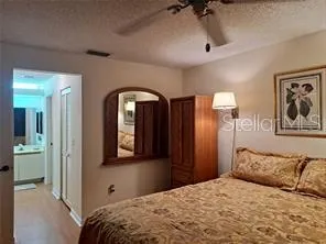 a bedroom with a bed and a mirror