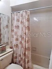a bathroom with a shower curtain and a toilet