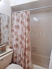 6807 Stone River Road, Unit 202 Bradenton, FL 34203 - Photo 6 of 12 a bathroom with a shower curtain and a toilet