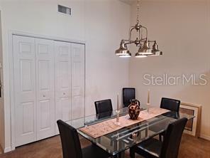 6807 Stone River Road, Unit 202 Bradenton, FL 34203 - Photo 7 of 12 a view of a dining room with furniture and wooden floor