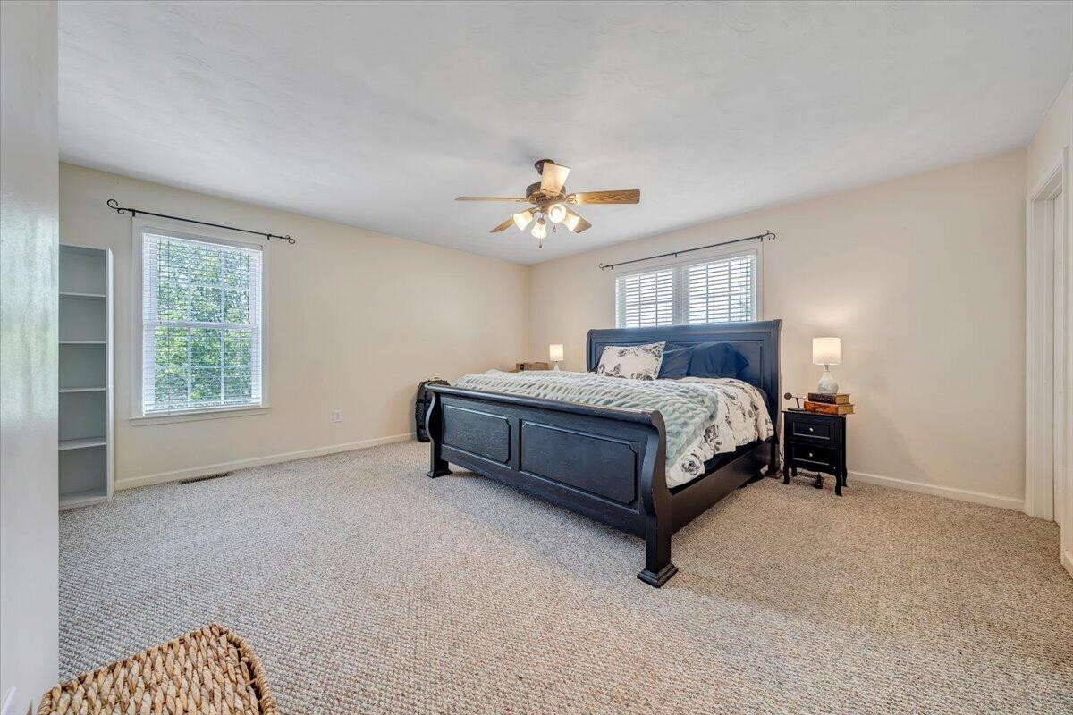 686 Pine Haven Road Fincastle, VA 24090 - Photo 21 of 56 a bedroom with a bed and a chandelier