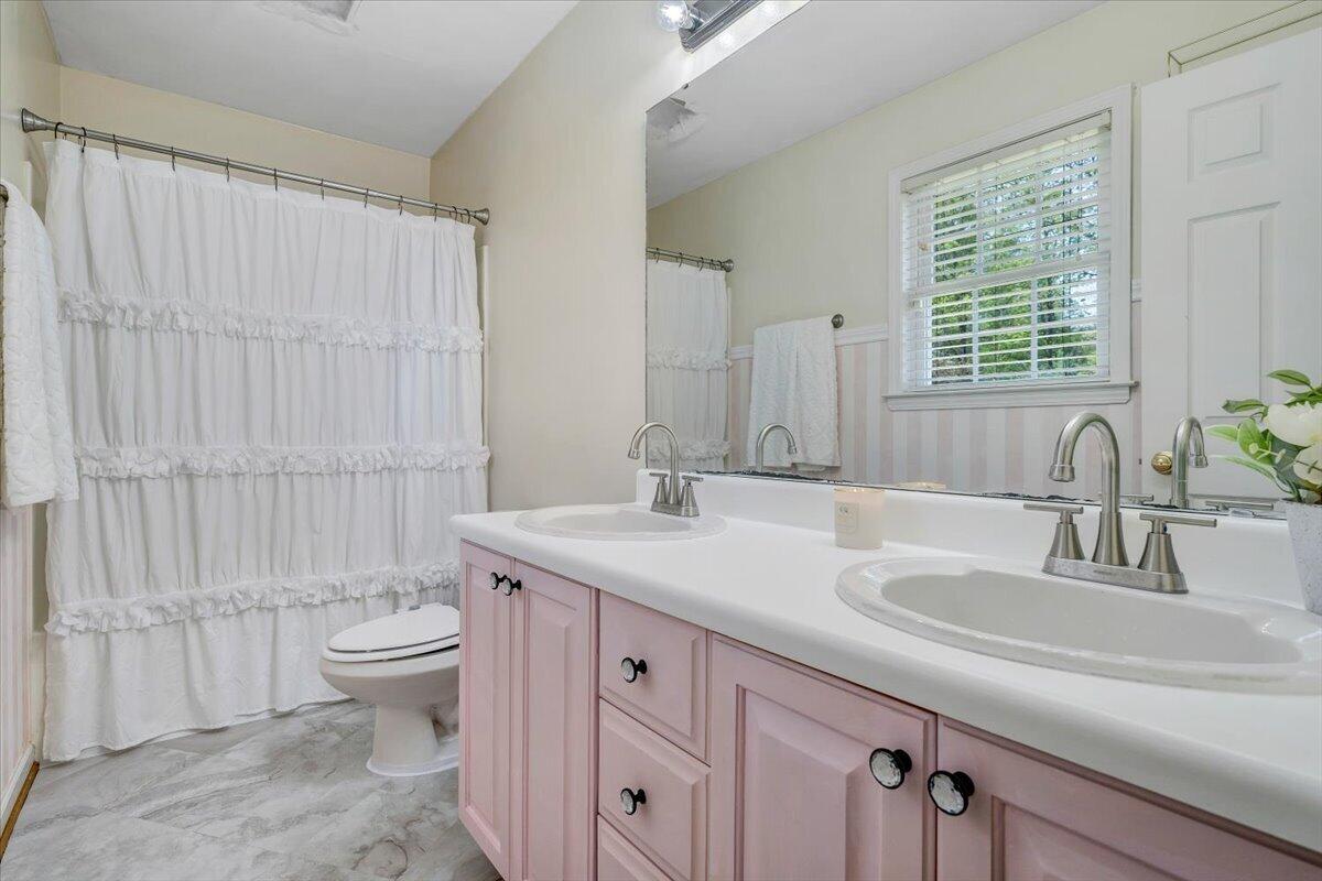 686 Pine Haven Road Fincastle, VA 24090 - Photo 28 of 56 a bathroom with a granite countertop sink a toilet a mirror and a shower