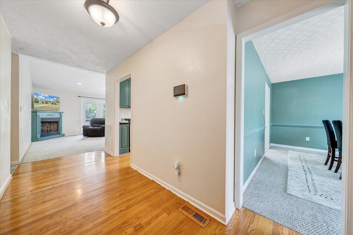 686 Pine Haven Road Fincastle, VA 24090 - Photo 4 of 56 a view of a hallway with wooden floor and furniture