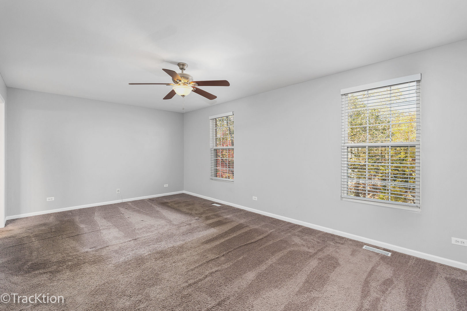 416 Conservatory Lane Aurora, IL 60502 - Photo 8 of 17 a view of a room with a ceiling fan and a window