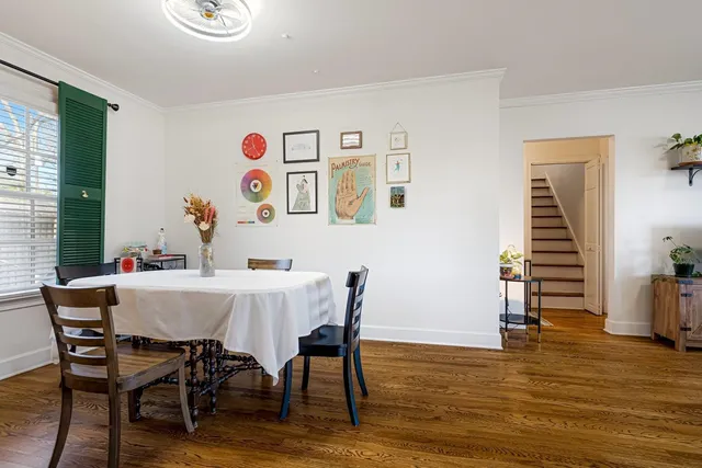 a view of a dining room with furniture and wooden floor