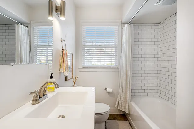 a bathroom with a sink a toilet and bathtub