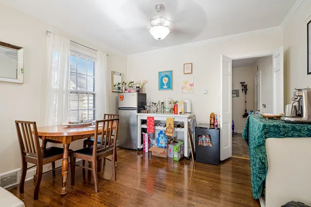 a view of a dining room with furniture and chandelier