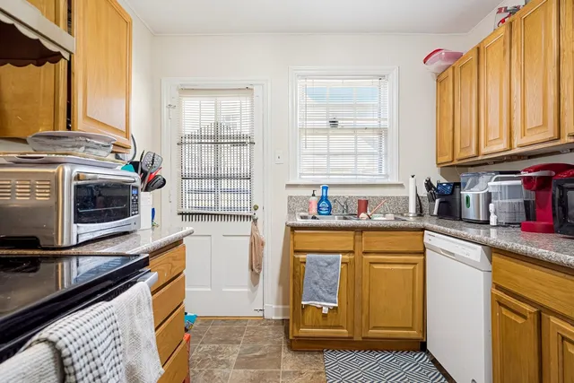 a kitchen with stainless steel appliances a stove a sink and a microwave