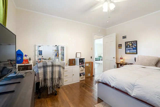 a bedroom with furniture and a wooden floor