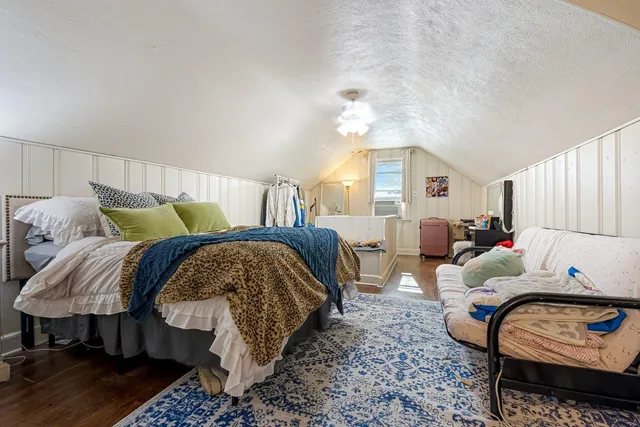 a bedroom with furniture and a lamp