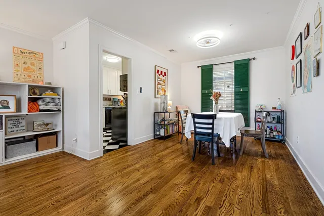 a dining room with furniture and wooden floor