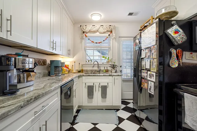 a kitchen with stainless steel appliances granite countertop a stove a sink and a refrigerator