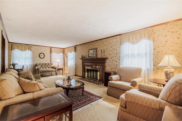6 James Road Reading, MA 01867 - Photo 3 of 30 a living room with furniture a fireplace and a flat screen tv