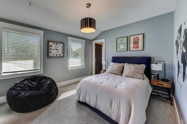 a bedroom with bed and a window