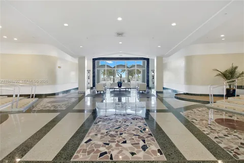 a view of a livingroom with furniture and an entryway