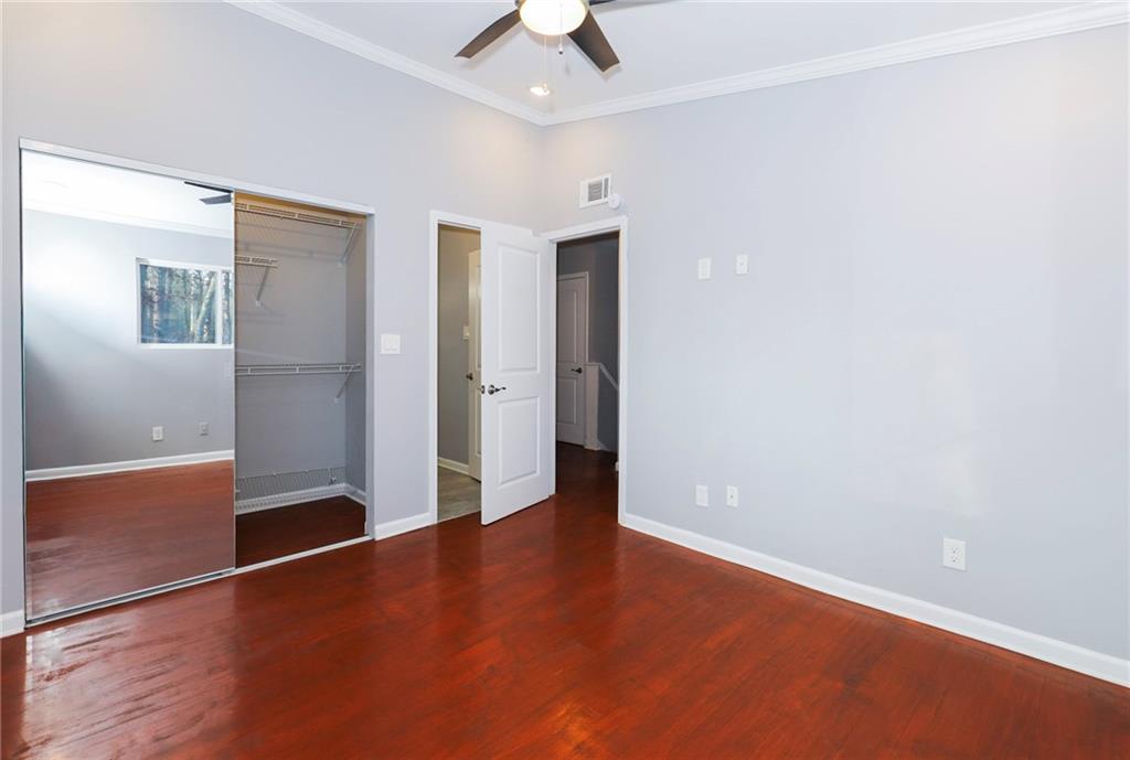 1277 Goodwin Road Northeast, Unit 1273 Atlanta, GA 30324 - Photo 12 of 18 an empty room with wooden floor and door